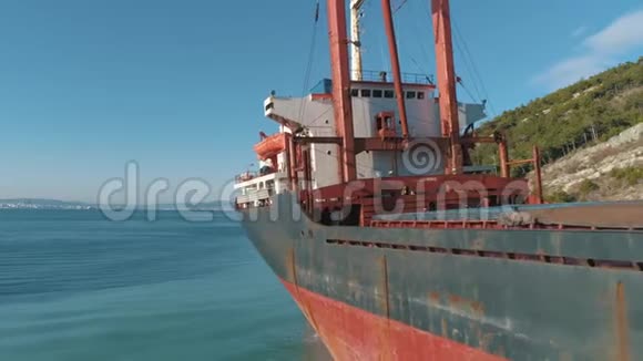 靠近海岸的码头上大型红色货船的特写镜头射击海上运输视频的预览图