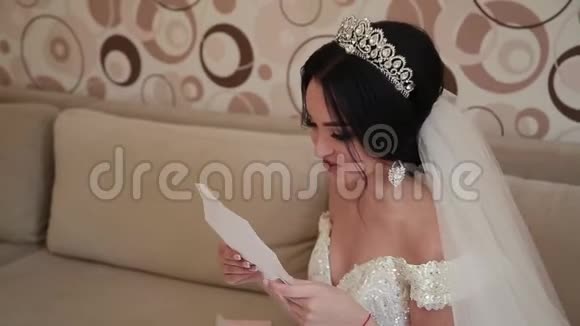 非常美丽的新娘打开并读一封来自爱人的信视频的预览图