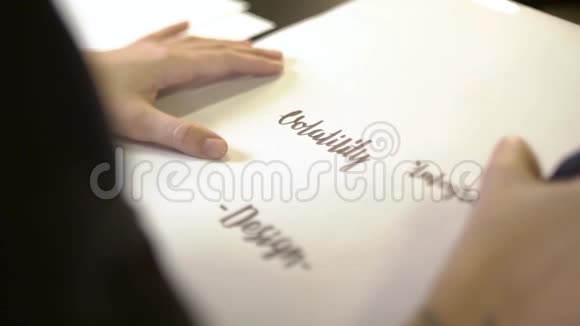 女性的侧视她的手在纸上书写视频的预览图