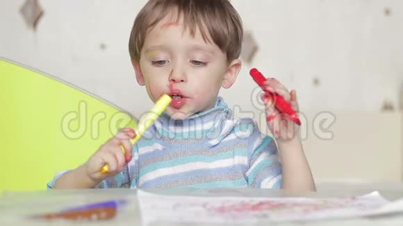 一个快乐的孩子的脸用一支毡尖的笔画出来一个肮脏的孩子笑着玩一支毛尖的笔视频的预览图