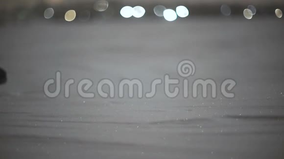 女人的特写镜头她的脚在雪地上行走斜射慢的月光视频的预览图