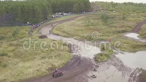 四轮自行车赛道的景观剪辑四轮自行车在比赛中通过泥坑的俯视图越野摩托车视频的预览图