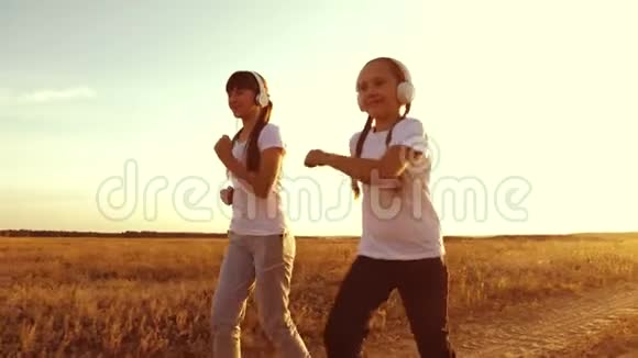 年轻女孩在日落时训练听音乐戴着耳机的少女在慢跑视频的预览图