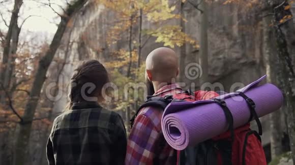 近距离家庭徒步旅行男孩和女孩站在高高的山上看着高高的岩石视频的预览图