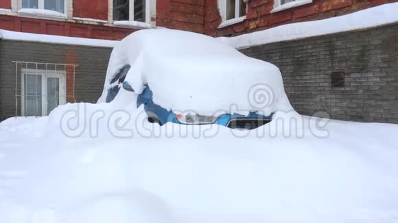 一辆蓝色的汽车在厚厚的一层雪下很多雪视频的预览图