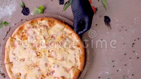 厨师用戴手套的手拿一片奶酪和培根比萨饼手特写视频的预览图