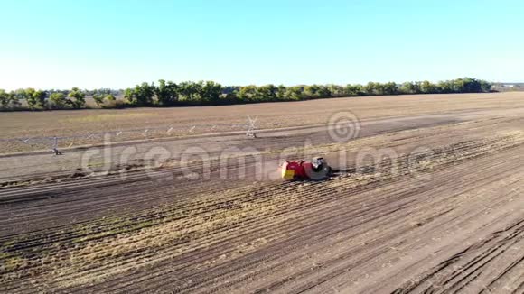 空中录像农业机械在农业领域收获新鲜的有机马铃薯加上拖拉机红色视频的预览图