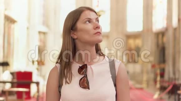 年轻的宗教女性游客在天主教会散步欧洲大教堂圣地内部视频的预览图