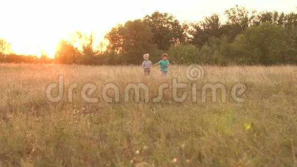 日落时分两个小男孩跑过田野慢悠悠视频的预览图