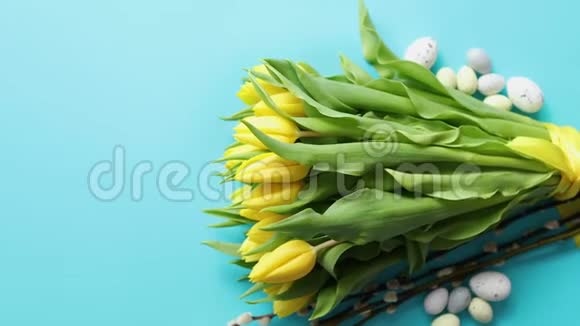 节日装饰与复活节彩蛋和黄色郁金香蓝色视频的预览图