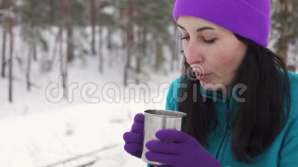 冬天一个女孩在大自然中喝热水视频的预览图