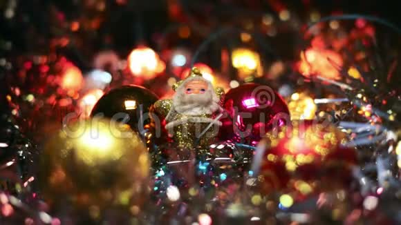 迷你圣诞老人的形象之间的四个玩具挂包为一棵圣诞树木制表面的金色圣诞老人视频的预览图