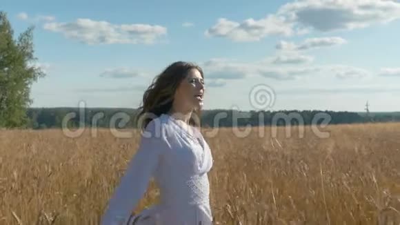 一位穿着白色连衣裙的歌手正在一片麦田里唱歌视频的预览图