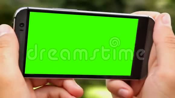 在带有绿色屏幕的智能手机上制作360度视频的人阿尔法频道视频的预览图