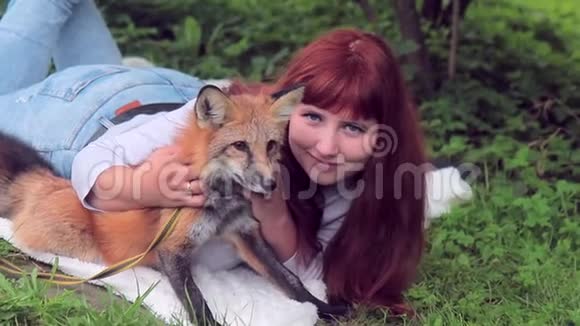 年轻女子躺在公园的草地上户外放着红狐视频的预览图