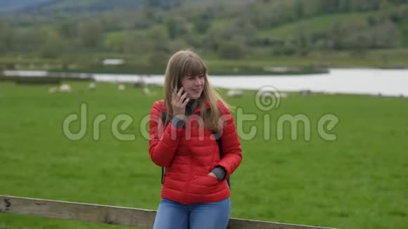 年轻女子站在典型的爱尔兰风景中打电话视频的预览图