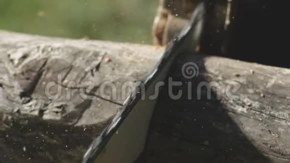 一个人用电锯锯木板一个人用锯木头从树上刮下来一个人用锯木头视频的预览图