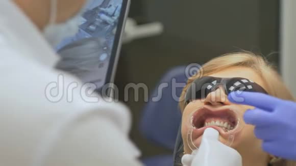 牙医在一个特殊的计算机程序加载到药片检查和调节咬带平板电脑的照片视频的预览图