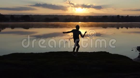 欢乐的人在夕阳西下的一个湖里跳迪斯科舞视频的预览图
