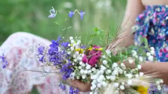 女性的双手构成夏日野花的花环视频的预览图