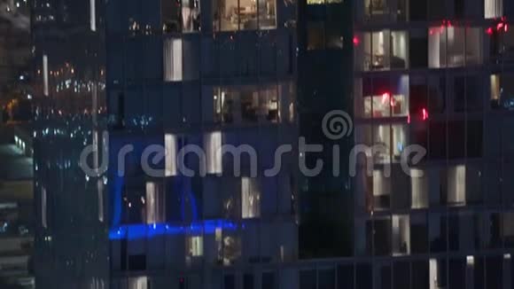 公寓楼外夜景窗户上闪烁着灯光的高层摩天大楼视频的预览图