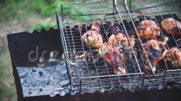 晚上用木炭烤的烤架烤着脆脆的鸡腿视频的预览图