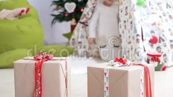 这个女孩正在孩子们小屋里玩耍圣诞节的气氛前台的礼物视频的预览图