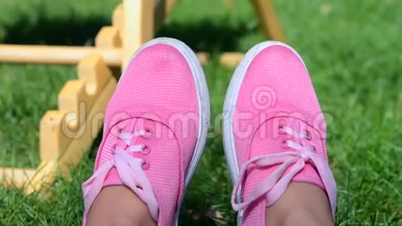 夏天穿着粉色衣服的女孩躺在绿草上视频的预览图