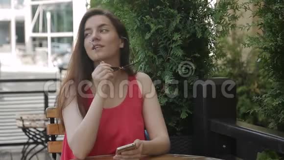 女士的肖像她坐在户外咖啡馆摘下太阳镜拍照视频的预览图