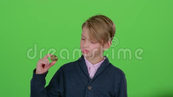 手里拿着芯片的少年消极地挥动着他的头把手放在绿色的屏幕上视频的预览图