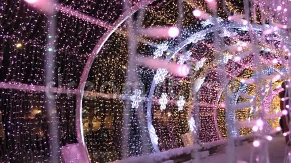 关闭彩色LED灯泡的花环在光隧道圣诞街道装饰城市新年准备视频的预览图