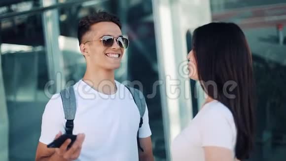 美丽的一对相爱的夫妇站在机场航站楼附近互相交谈商业合同交易视频的预览图