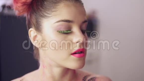 化妆师用刷子涂口红来模拟的嘴唇假睫毛模特准备参加时装秀视频的预览图