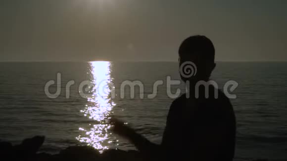 日落时分一个女孩在海滩上挥手视频的预览图