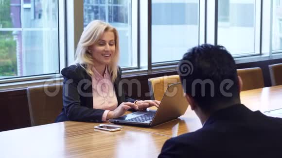漂亮的商务女性坐在电脑前说话视频的预览图