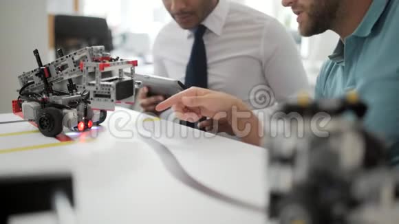 两位同事在工作室检查机器人视频的预览图