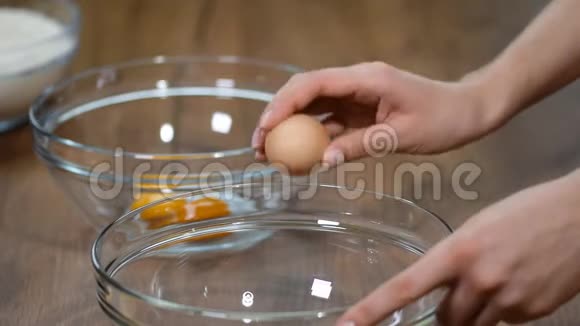 女人用手在蝴蝶结上打碎鸡蛋鸡蛋黄掉下来视频的预览图