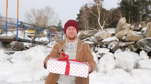 年轻人在冰雪背景下送礼物视频的预览图