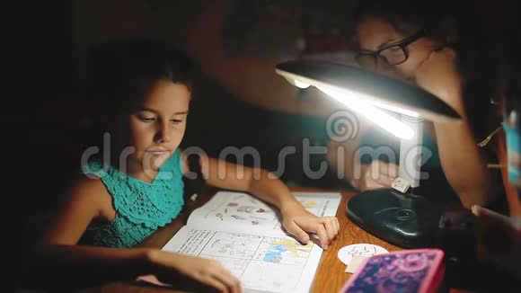 小女孩晚上做家庭作业读一本书和作家晚上做家庭作业女孩课从视频的预览图