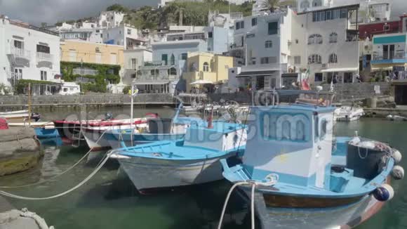 美丽的渔船停在度假小镇码头附近建筑物景观视频的预览图
