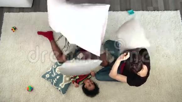 快乐的家庭在地板上打枕头战视频的预览图