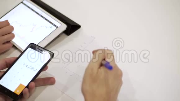 商人们在一个带有图表的平板电脑上工作视频的预览图
