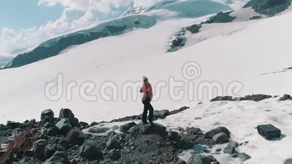 空中射击女子在雪山上的岩石上跳舞风景如画视频的预览图