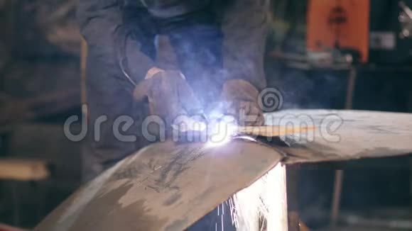 一家工厂的男工戴着防护手套和工作服正在用氧乙炔割炬切断金属片视频的预览图