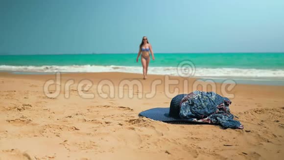 小女孩从海里出来从沙子里举起衣服中弹斯隆运动视频的预览图