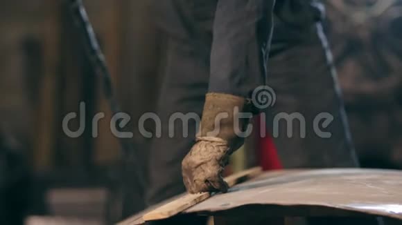戴防护手套的工人手拿木板调整金属结构上的切割线切割视频的预览图