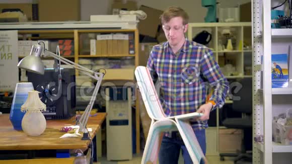 一个男人拿起一张3D打印的儿童椅子视频的预览图
