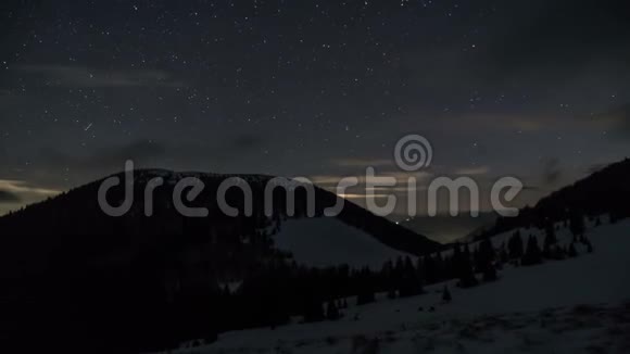夜空中的星和云在冬天的山脉上移动做梦的天文时间流逝视频的预览图
