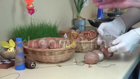 厨房里的洋葱和袜子用手缠绕染色复活节彩蛋4K视频的预览图