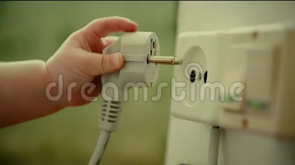 婴儿的手插电子插头在墙上插座视频的预览图